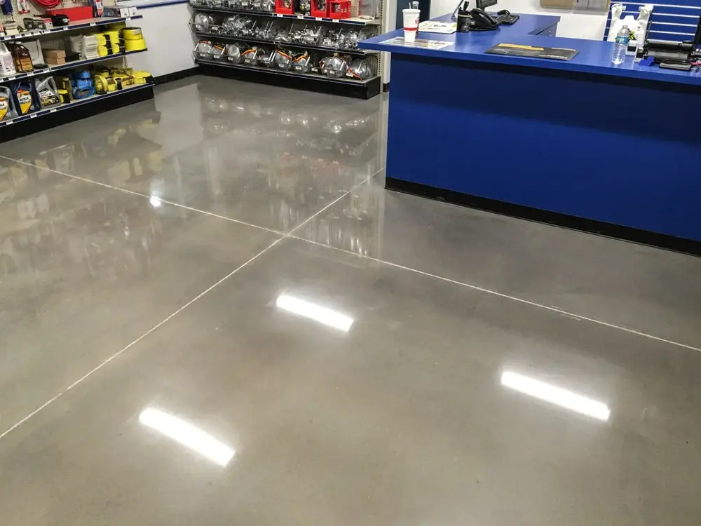 Polished concrete floor in a retail parts store with clean saw-cut joints, finished by Core Floorings Inc